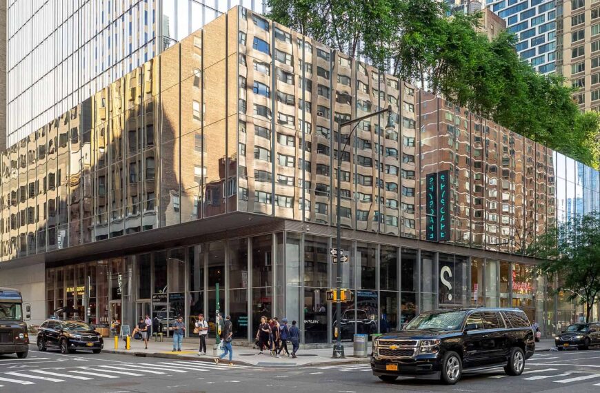 The mirrored corner of the Spyscape building in Midtown Manhattan, reflecting the surrounding towers