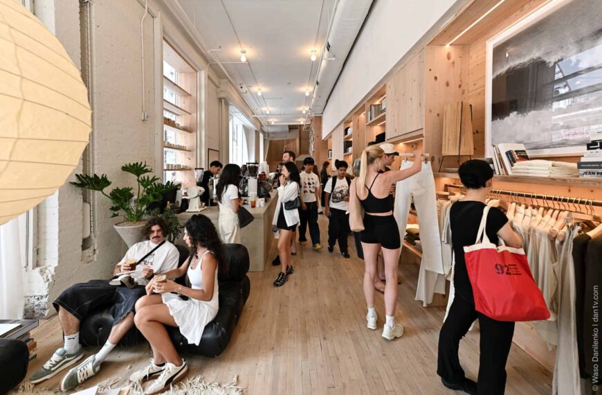 Ground floor of the Buck Mason SoHo store, coffee bar on the left and clothing rails along the right wall