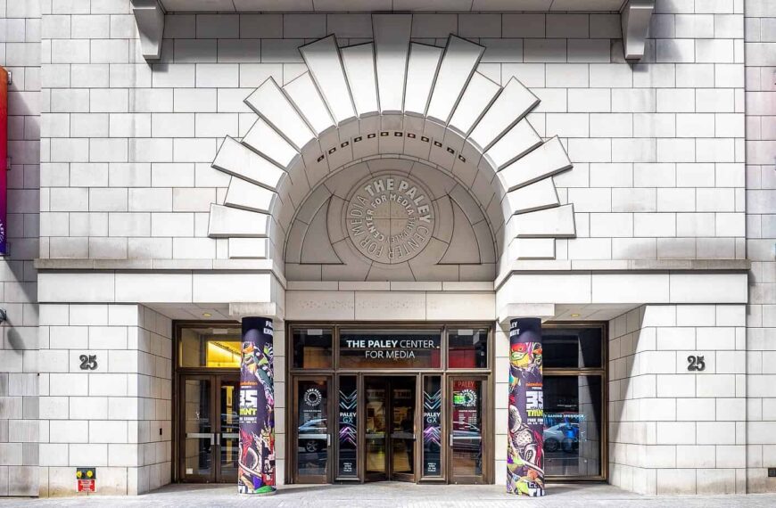 The limestone entrance of the Paley Center for Media, framed by a fan-shaped Art Deco arch above the doors