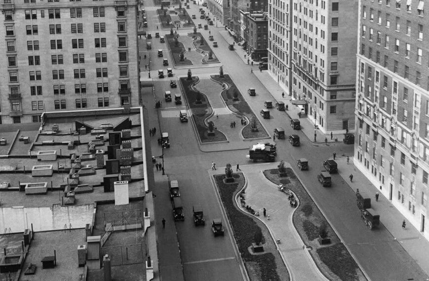 A black and white aerial view of New York City streets and parks.
