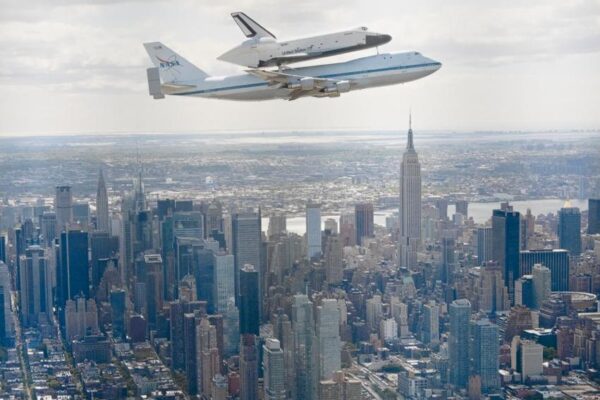The flight of the space shuttle Enterprise over Manhattan on a Boeing 747