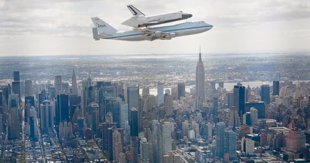 The flight of the space shuttle Enterprise over Manhattan on a Boeing 747