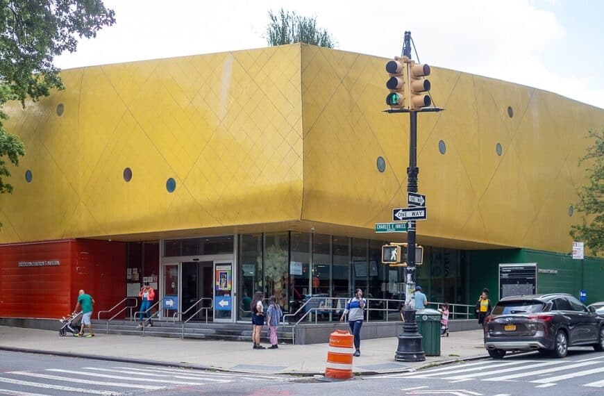 The Brooklyn Children's Museum, a yellow corrugated building dotted with round windows, on a Crown Heights corner