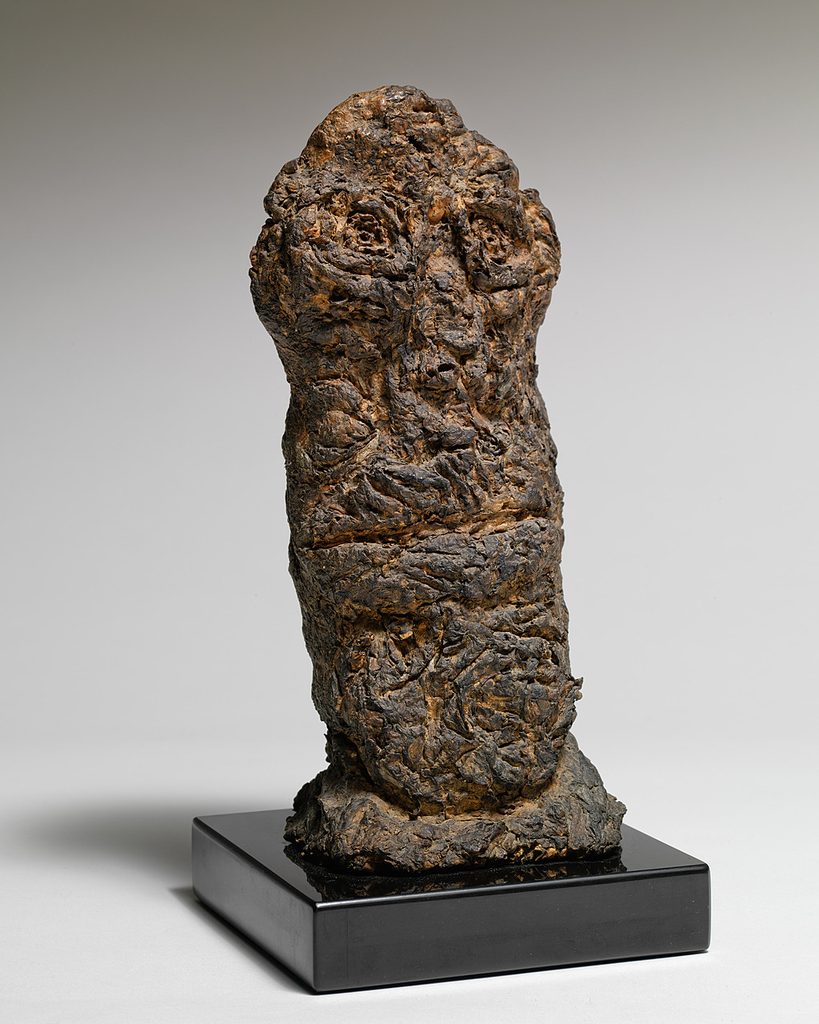 The Big-Chinned One, a small dark Dubuffet sculpture shown on a black base