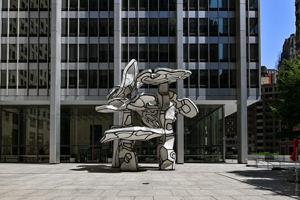 Group of Four Trees on the open granite plaza at 28 Liberty Street, seen from across the square